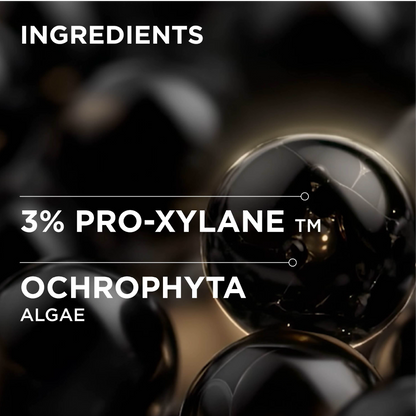 Ingredients graphic showing '3% PRO-XYLANE TM OCHROPHYTA ALGAE' over a dark glossy background with black and dark brown reflective spheres.
